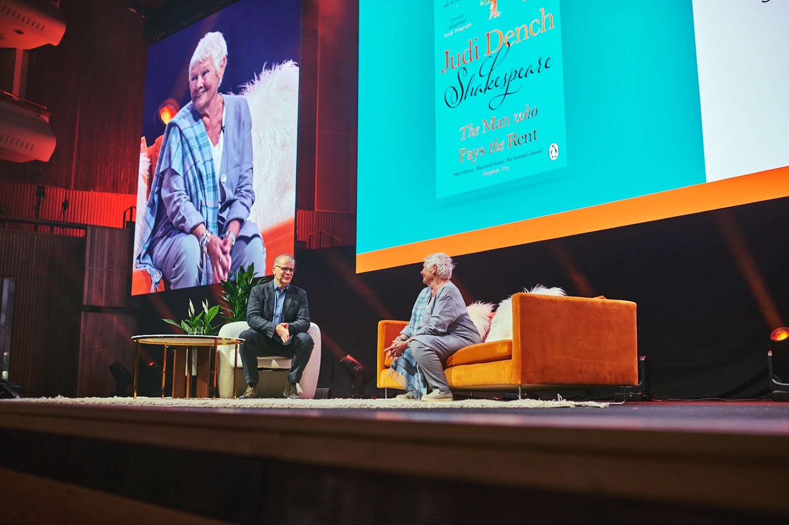 An author in conversation on stage at a Penguin Presents talk