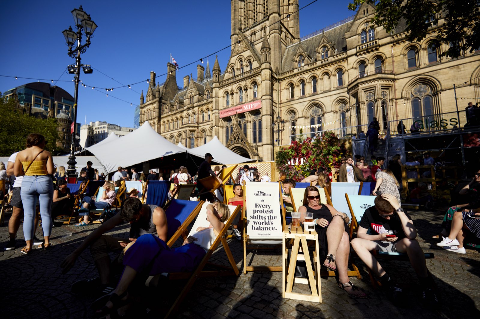 Audiences in deckchairs outside Manchester Town Hall during Rise Like Lions in Albert Square